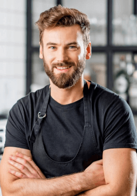 A smiling chef with a mischievous grin